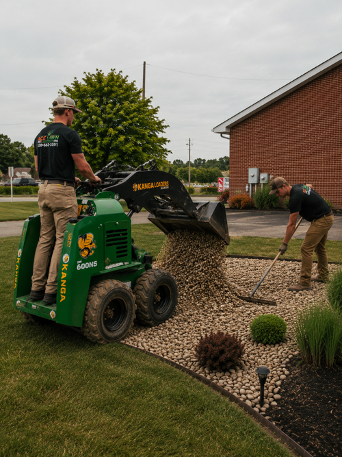 Decorative rock bed being installed with a track loader